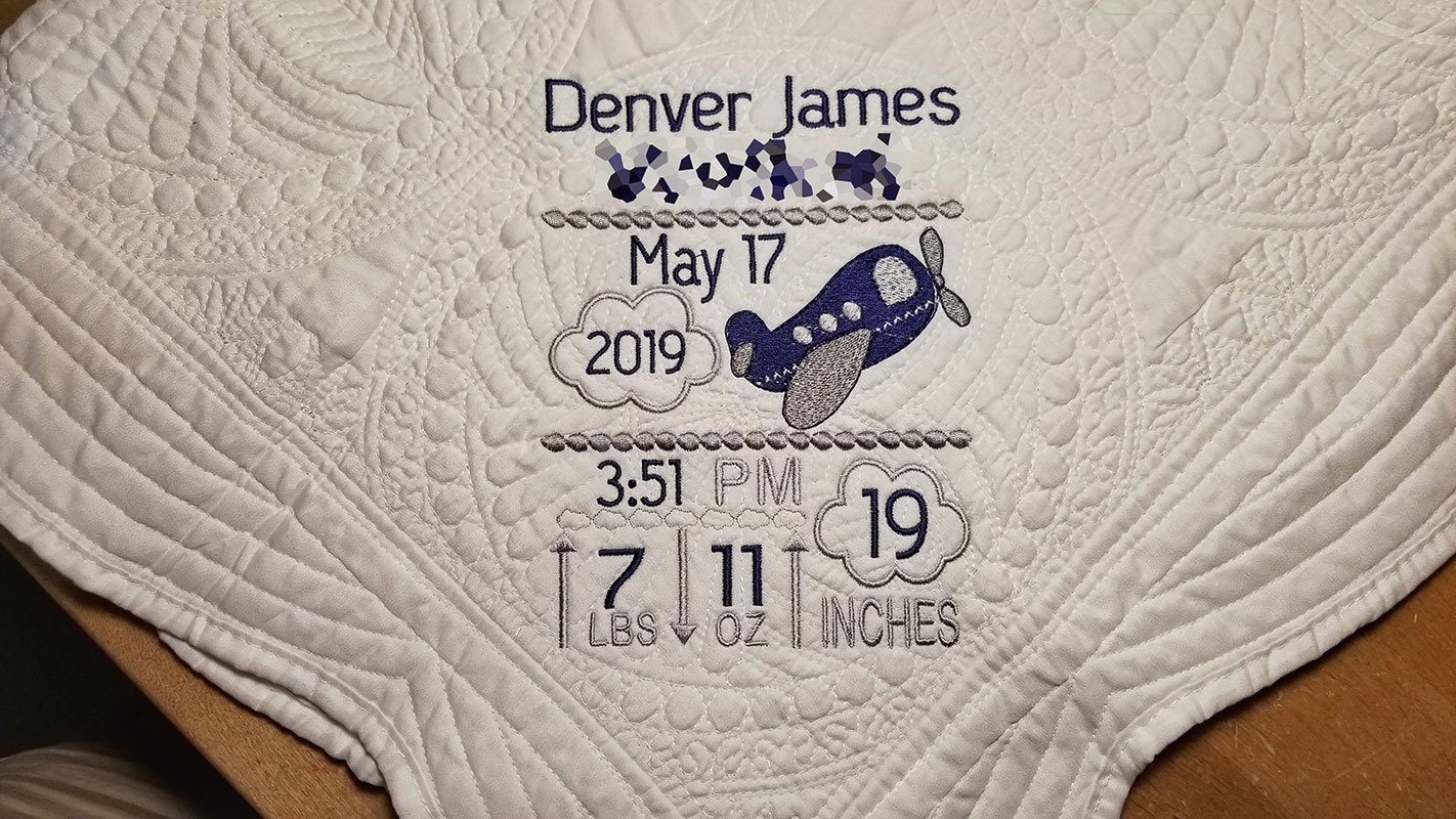 Personalized baby blanket with embroidered name and birth information