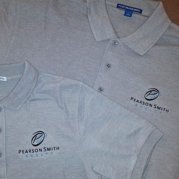 Men's Polo Style K500 & Ladies' Style L500 both embroidered with the Pearson Smith logo on the left chest