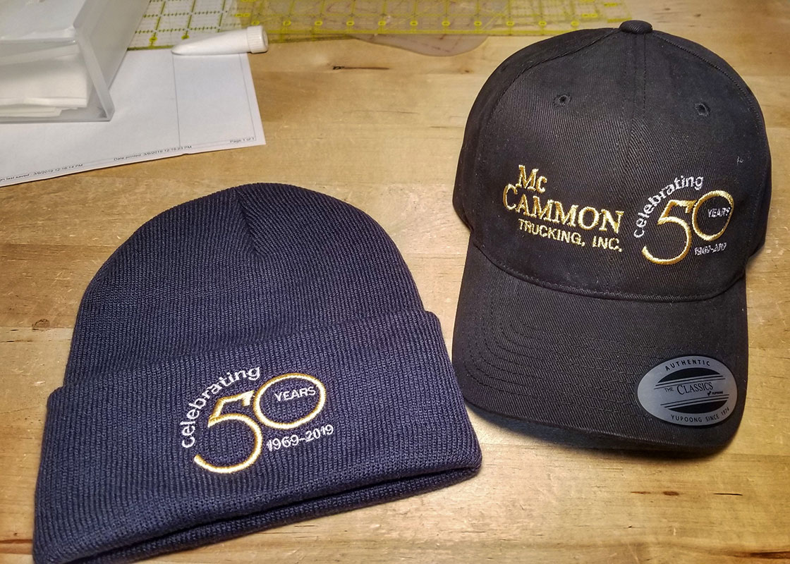 Knit Cap and Baseball Cap Embroidered with logos for McCammon Trucking Celebrating 50 Years