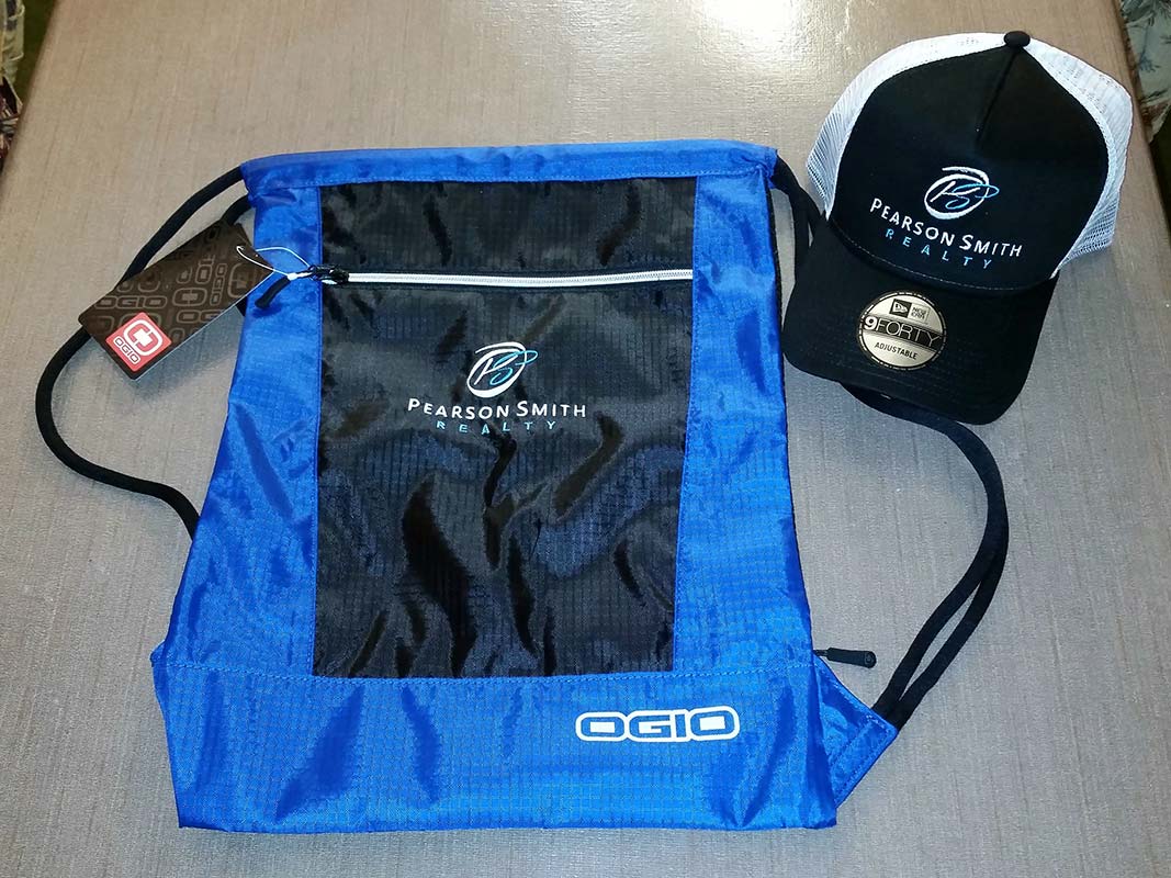 Cinch Pack and Baseball Cap embroidered with Pearson Smith Realty logo