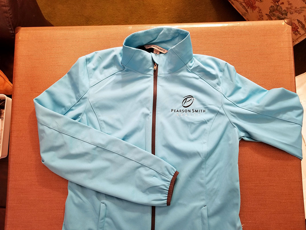 Jacket with Pearson Smith Realty logo embroidered on left chest
