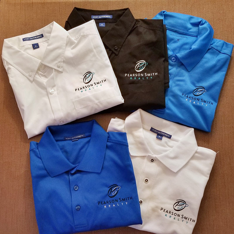 Polos and button-down shirts with Pearson Smith Realty logo embroidered on left chest