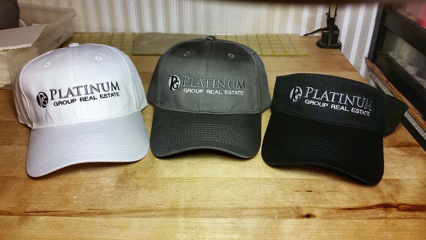 Custom embroidered baseball caps and visor for Platinum Group Real Estate