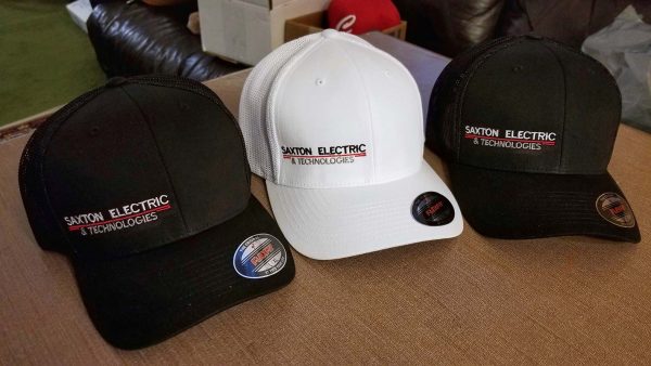 Three baseball caps embroidered with Saxton Electric & Technologies logo