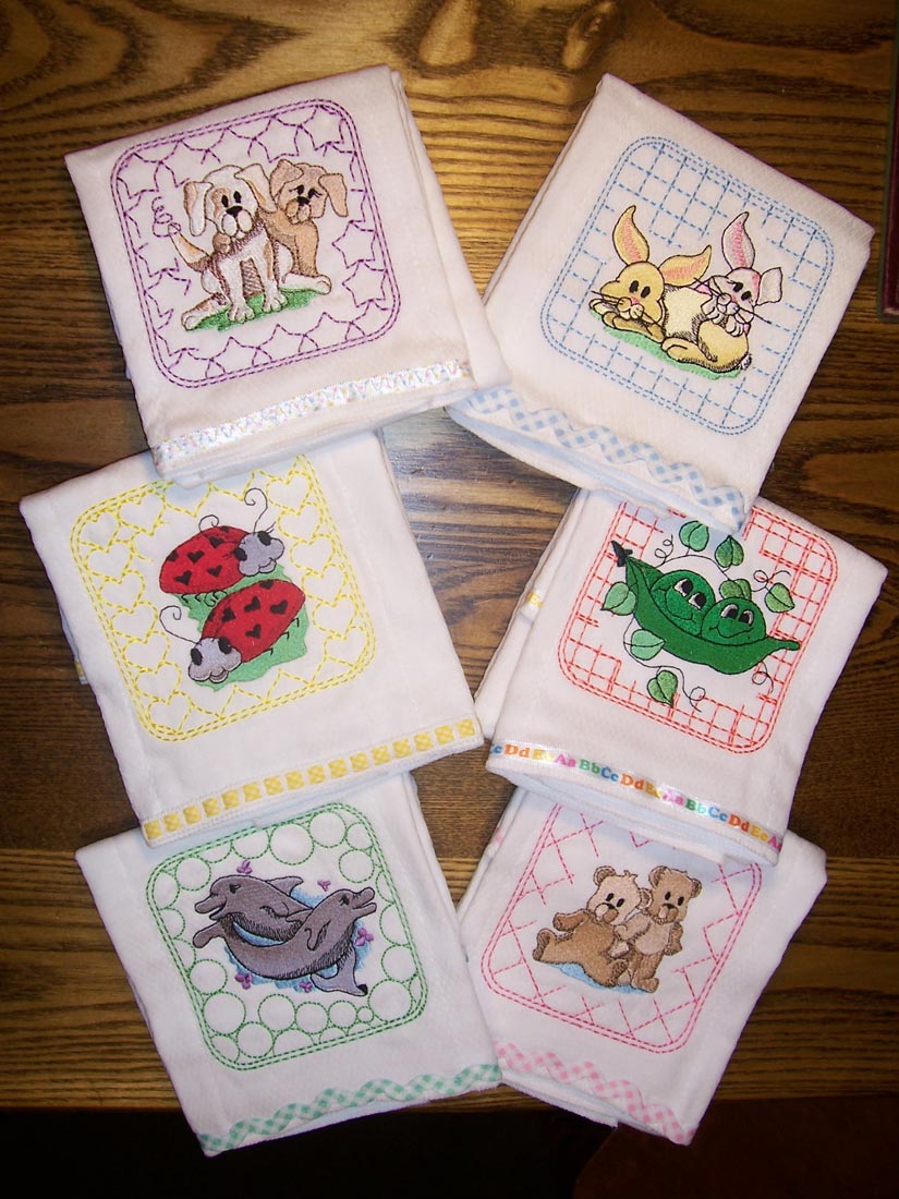 Set of six baby burp cloths, each embroidered with a cute design of dogs, ladybugs, dolphins, bunnies, peas in a pod, or bears.