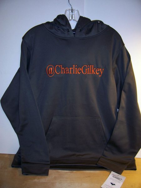 Dark gray hoodie with the twitter handle @CharlieGilkey embroidered in bright orange across the chest