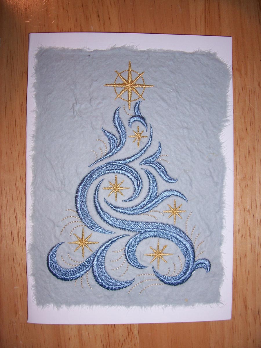 Embroidered Christmas Card, the front of which is a blue stylized Christmas tree with gold star-like decorations on a blue texturized paper background.