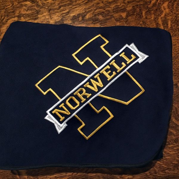 Navy fleece blanket with a gold capital N and a white banner with gold letters that says NORWELL running across it